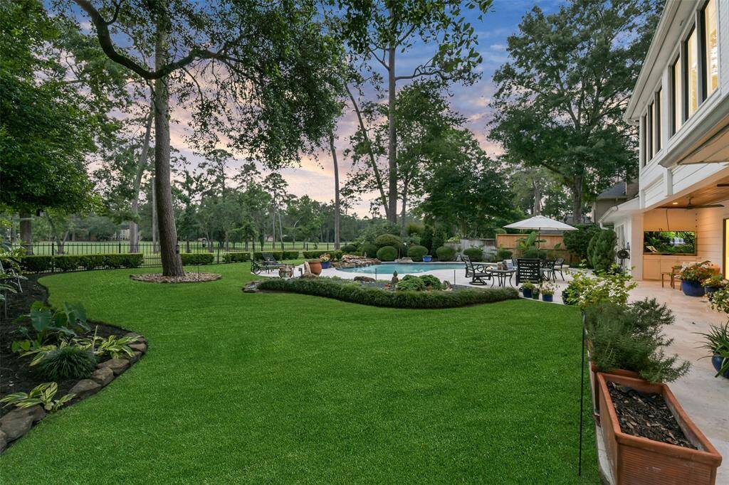 Pleanty of green space by the pool and covered patio with TV.