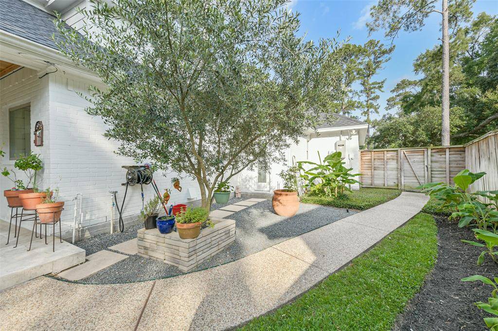 Side of house showing outdoor kitchen and door to the half bath.