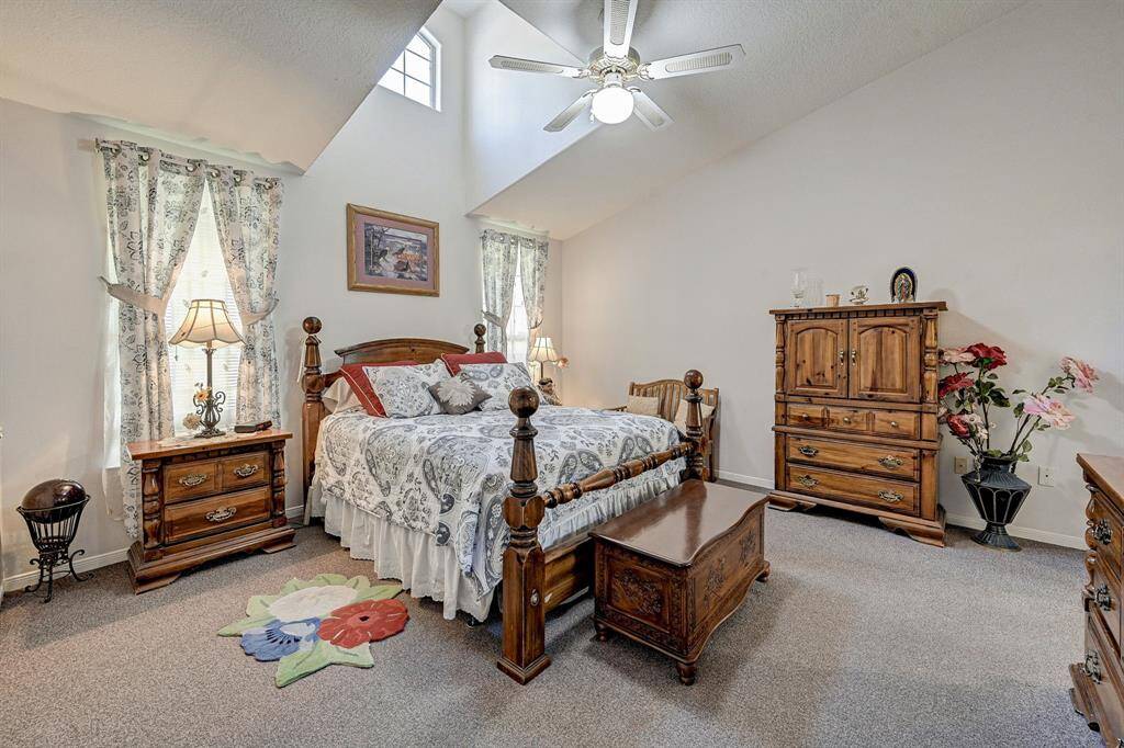 MASTER BEDROOM WITH CARPET AND LOTS OF LIGHT