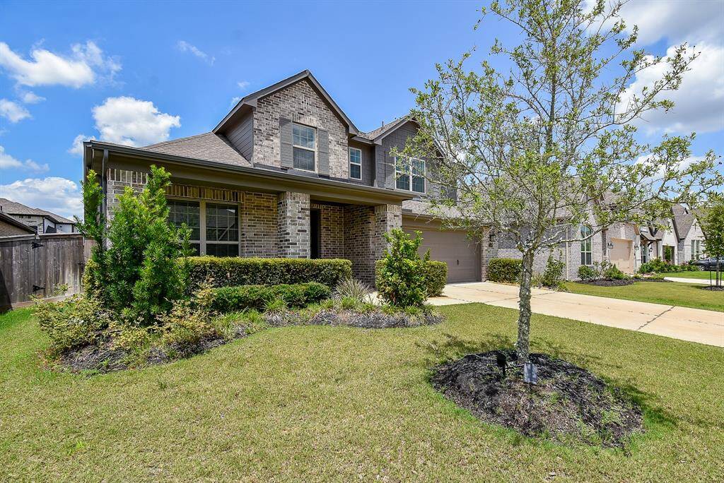 A graceful blend of classic brickwork and fresh landscaping sets the tone for this elegant two-story. The wide driveway leads to a two-car garage, while the spacious front lawn offers both curb appeal and breathing room.
