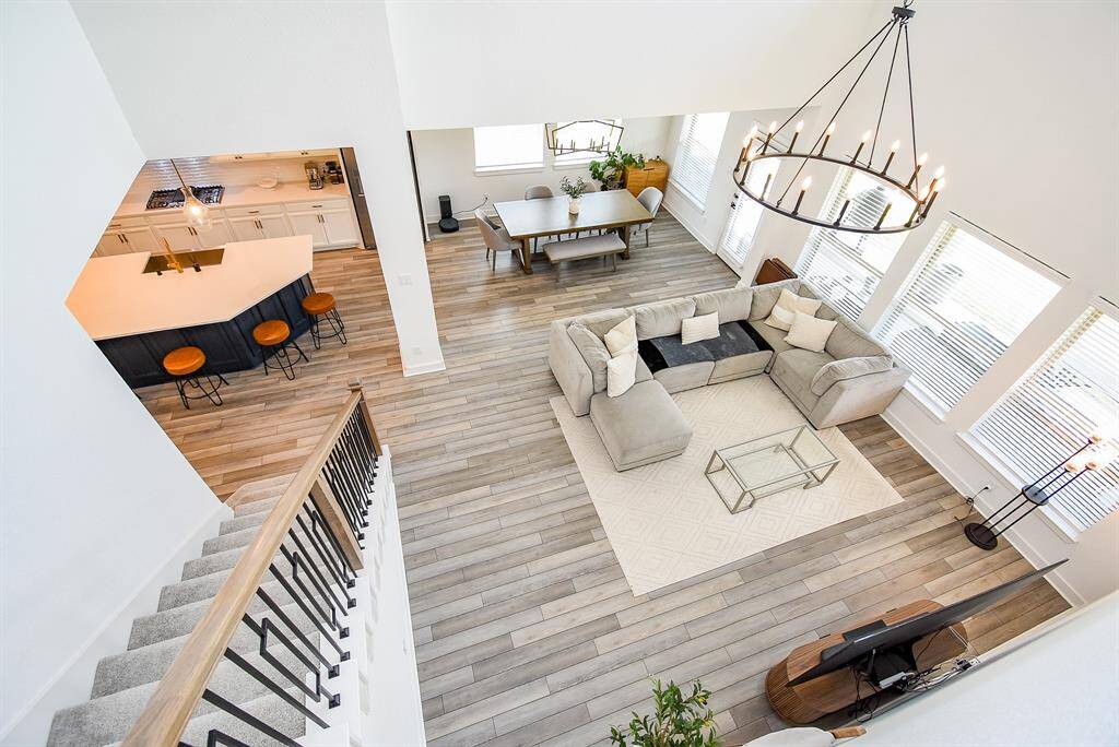 Looking down from the upper level reveals the harmony of the open plan—airy, bright, and thoughtfully designed to feel both grand and grounded.