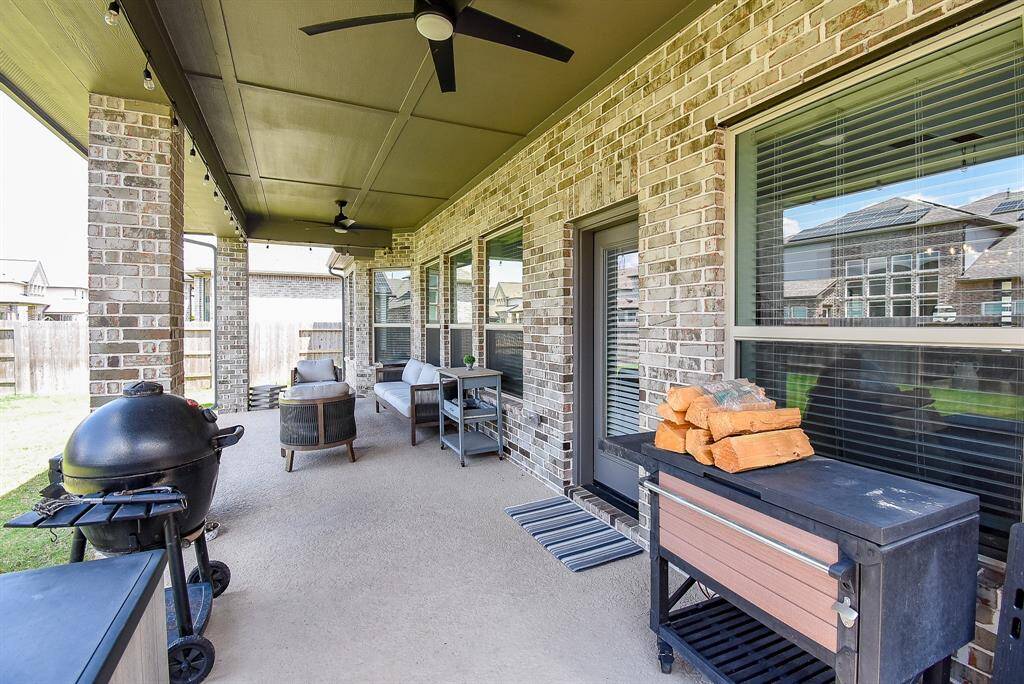 Stretching across the rear of the home, the covered patio includes two ceiling fans and generous space for both dining and lounging. A natural extension of the home for year-round outdoor living.