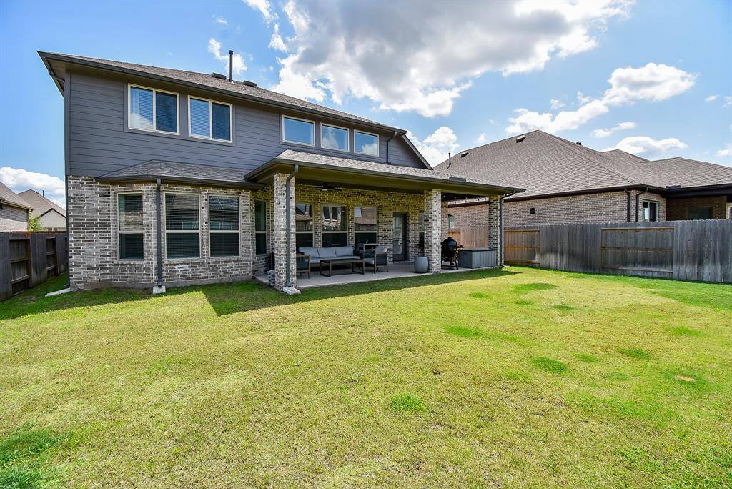 Enclosed and expansive, the backyard is a canvas of green—ideal for play, pets, or peaceful afternoons.