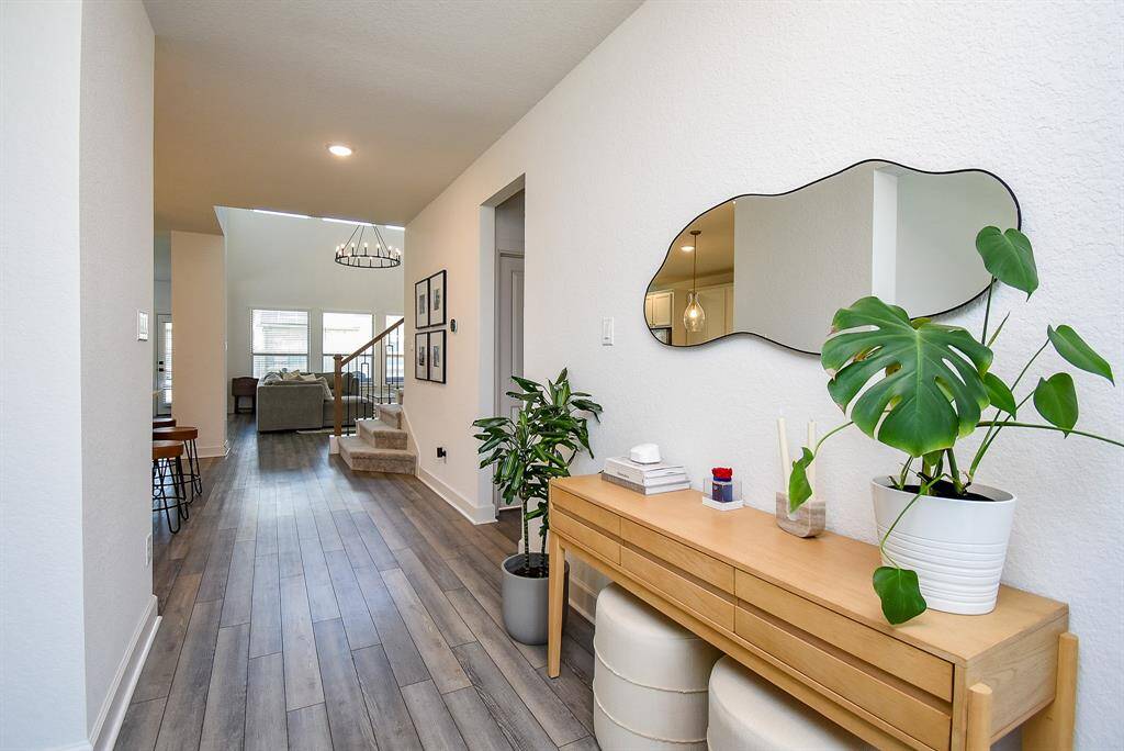 Step inside to a light-filled foyer that instantly draws your eye toward the thoughtfully connected living spaces ahead.