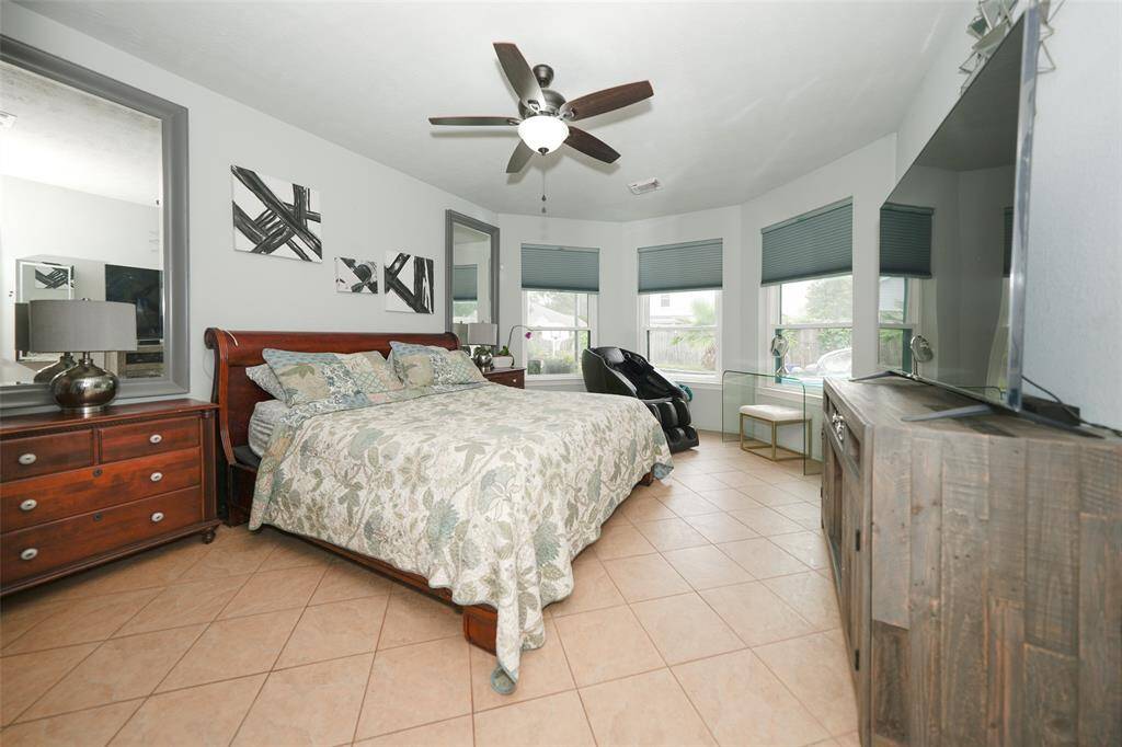 Spacious primary bedroom on first floor with pool view