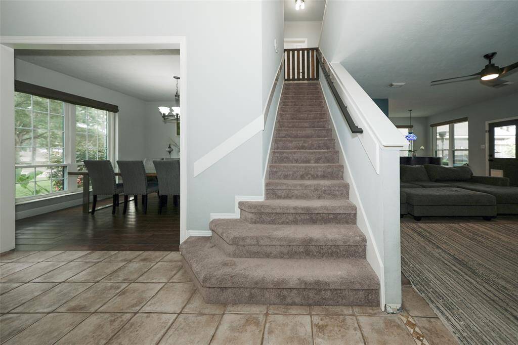 Stairway to 3 bedrooms, a full bath, and game room