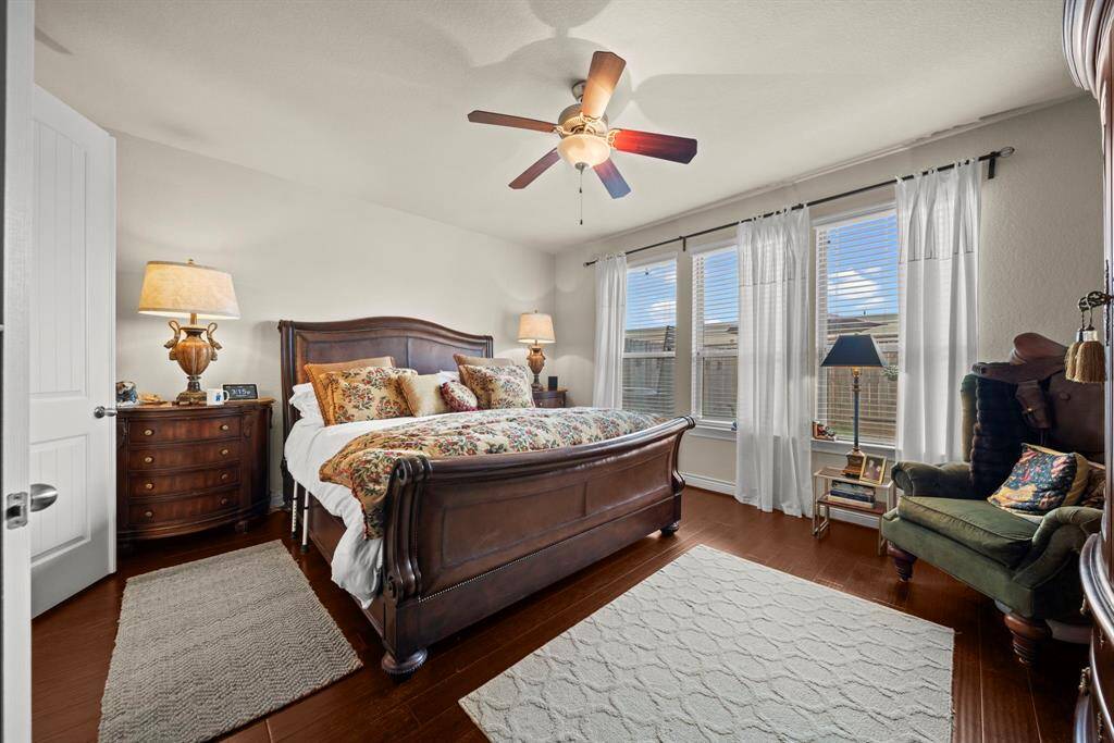 The primary bedroom is downstairs and has engineered wood floors as well as lovely windows