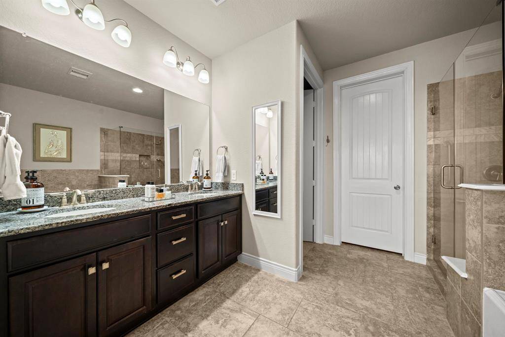 The primary bathroom with dual sinks, a soaking tub and large shower