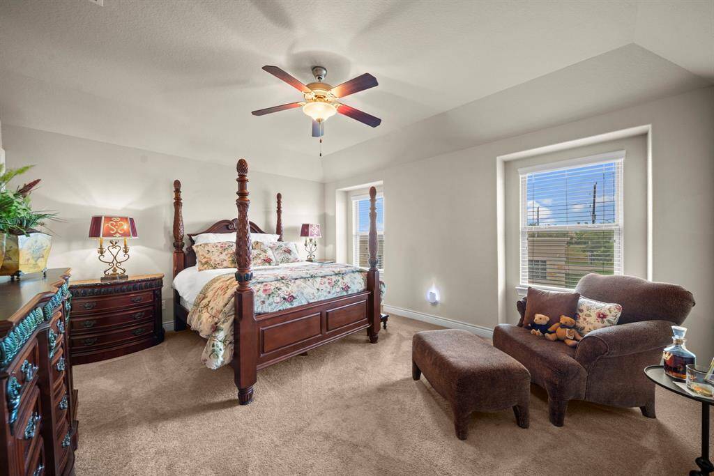 The large bedroom upstairs with high ceilings, plush carpet and sky views