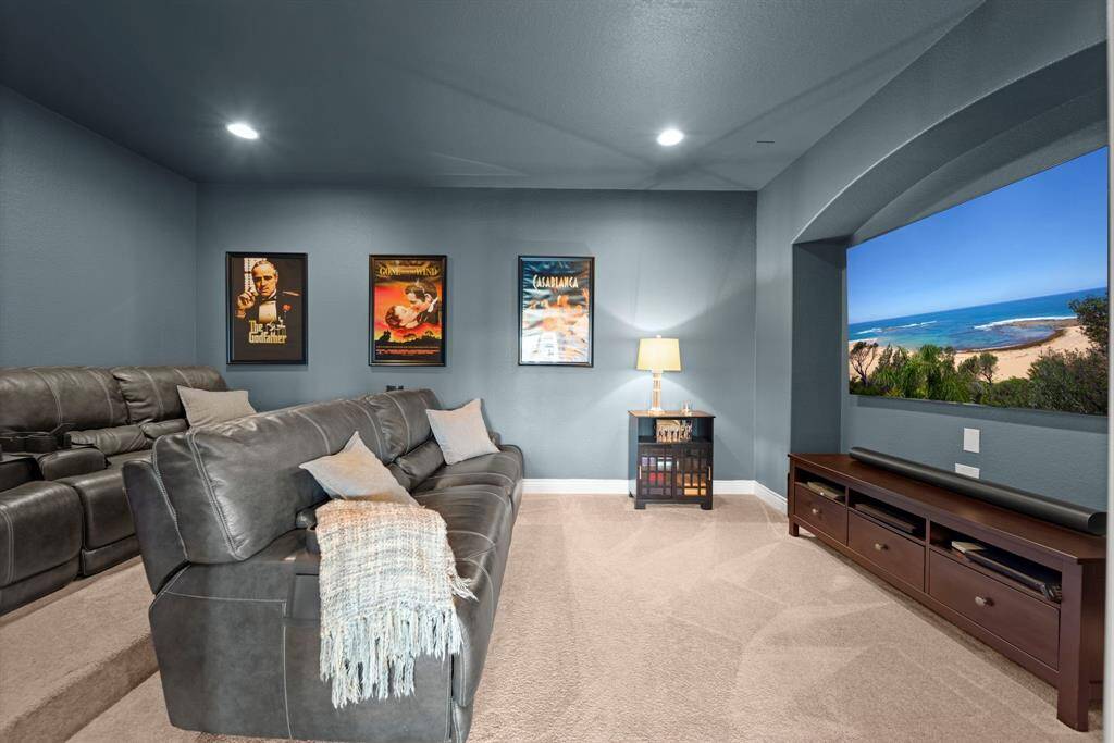 The  media room is perfectly outfitted for your entertainment needs. The second row riser ensures everyone has a terrific view of the screen