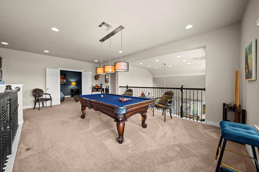 The gameroom overlooks the kitchen and living area downstairs