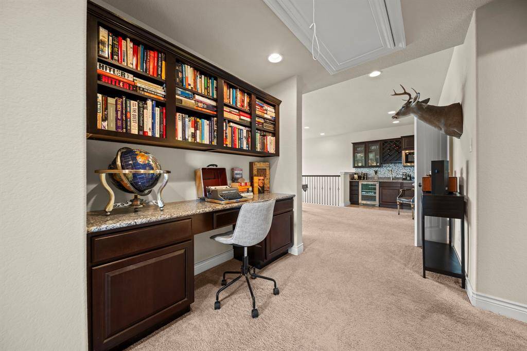 The upstairs hallway boasts a beautiful builtin desk and workspace. With large granite counters and built in bookcases to store your work/school materials