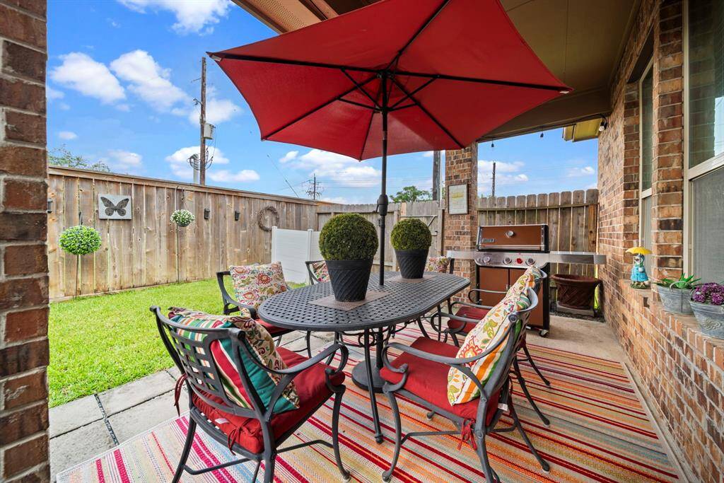 Your private, covered back patio with no rear neighbors and greenspace on one side