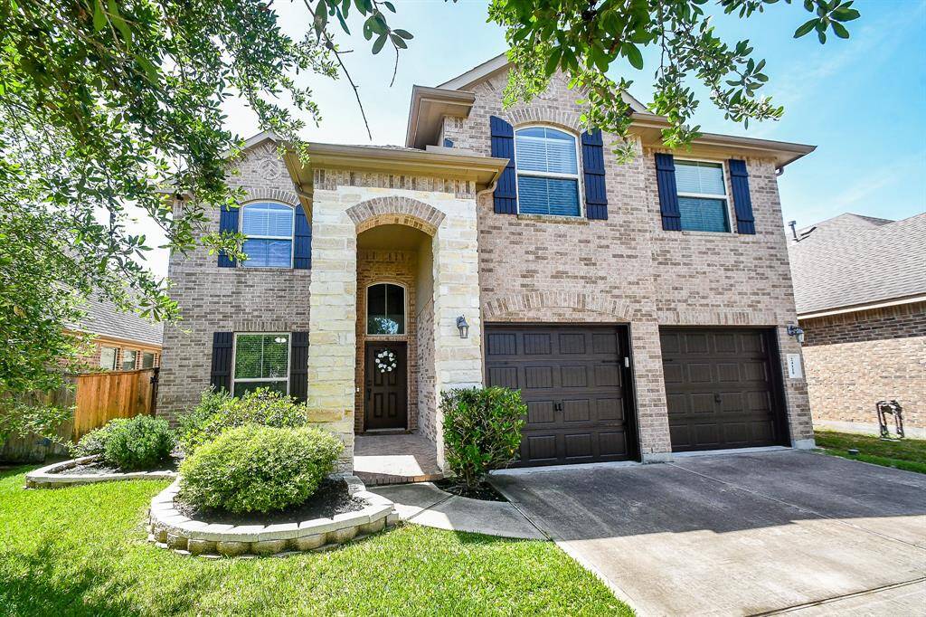 This gorgeous home stands out with it's Espresso Shutters, Door and Garage Doors
