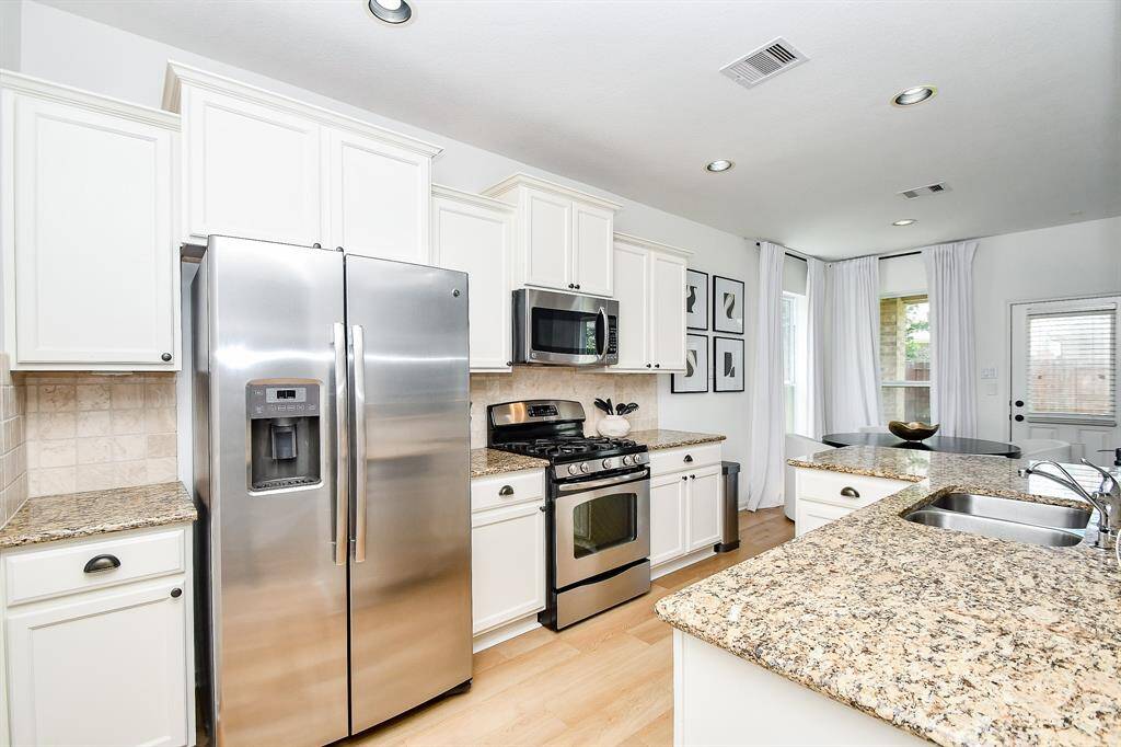 Stainless steel appliances and granite counter tops give the kitchen a modern look.