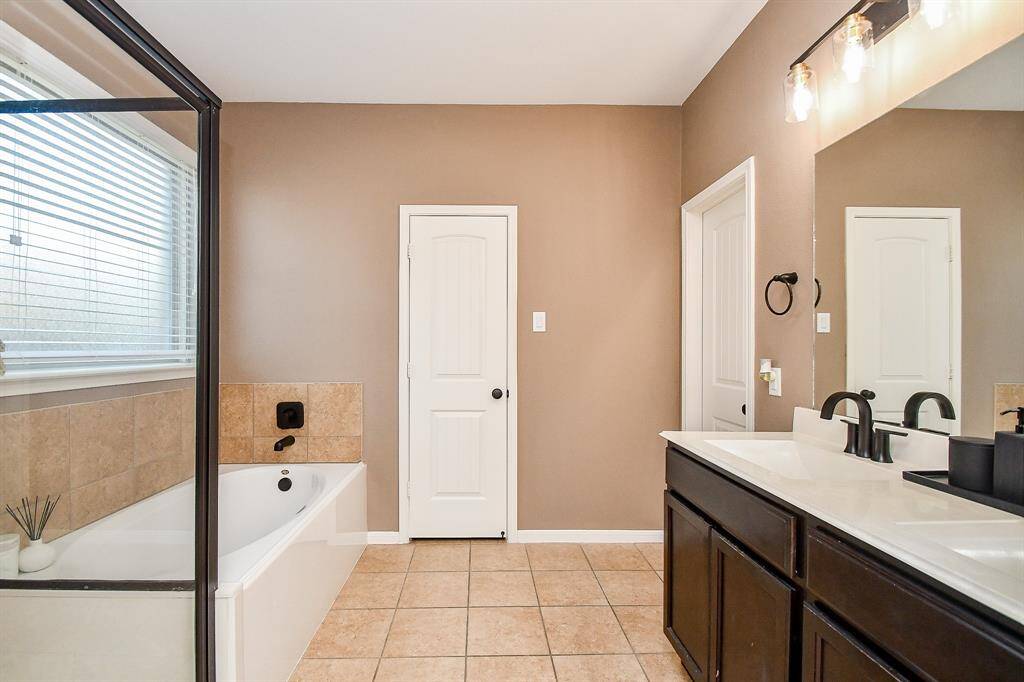 The primary bath is an oasis, with 2 sinks, and separate shower/bath tub, private toilet room and roomy walk-in closet.