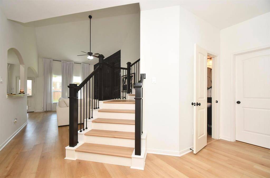 The living area beckons from the foyer (half-bath, laundry and garage doors to the right)