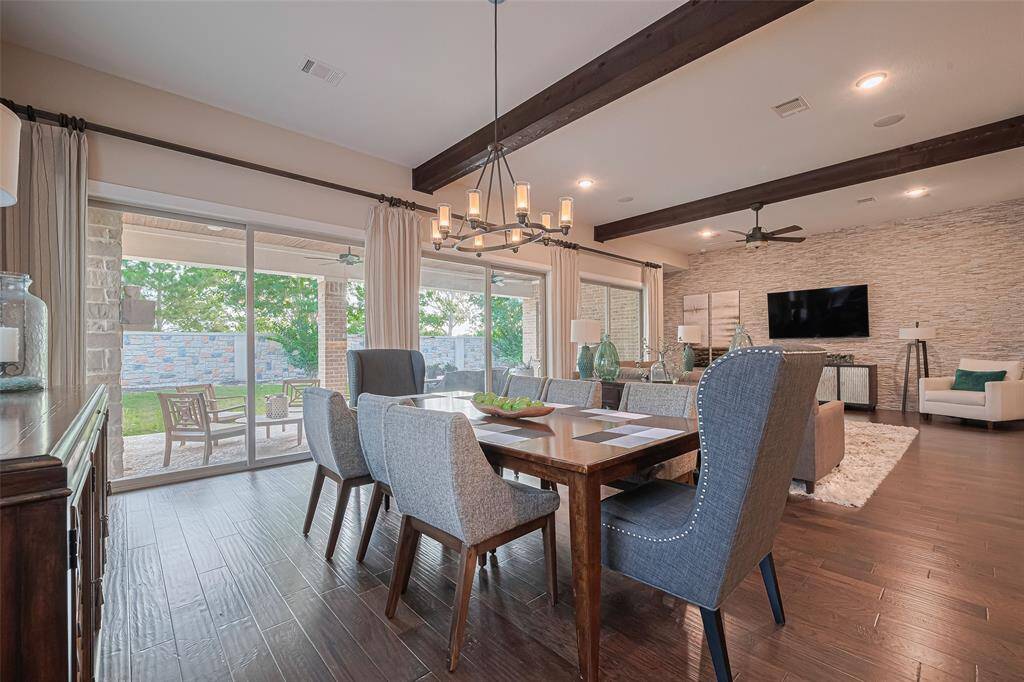 Formal dining open to the living and the kitchen with a beautiful designer fixture