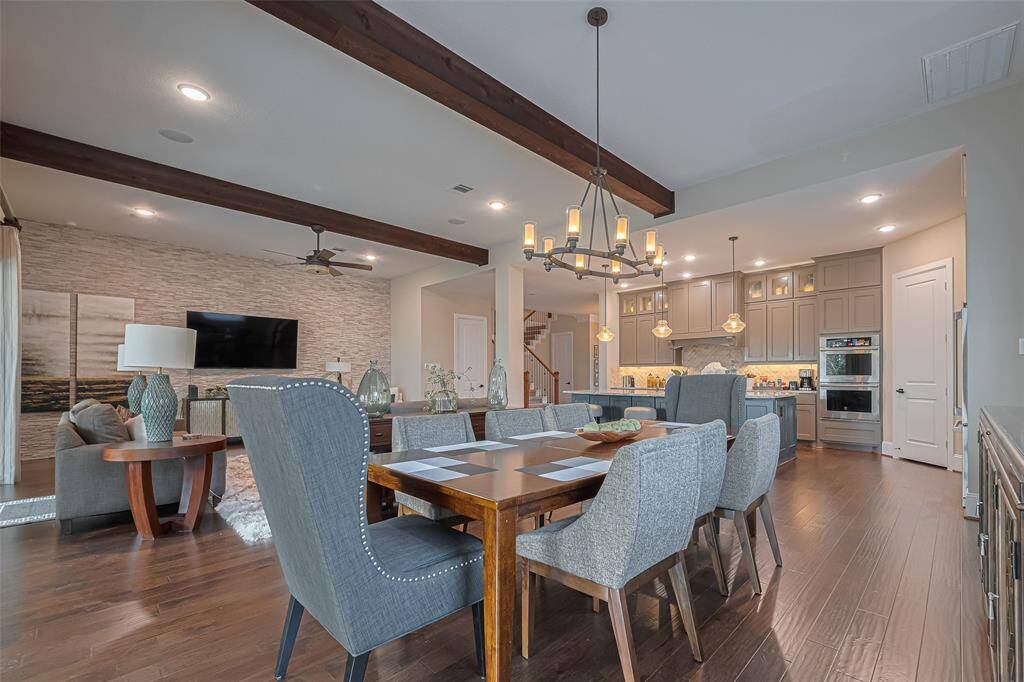 Wood floors, ceiling beams, feature wall, designer fixtures