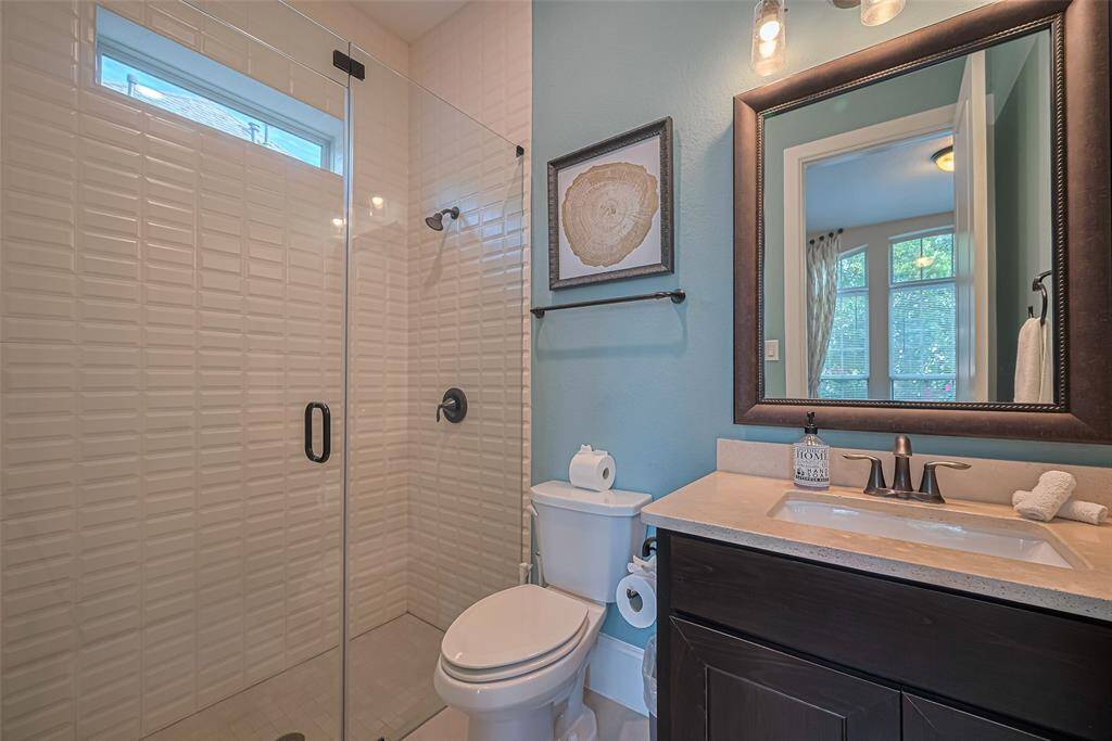 Here’s the private en suite for the second bedroom down with floor to ceiling tile shower and frameless glass door