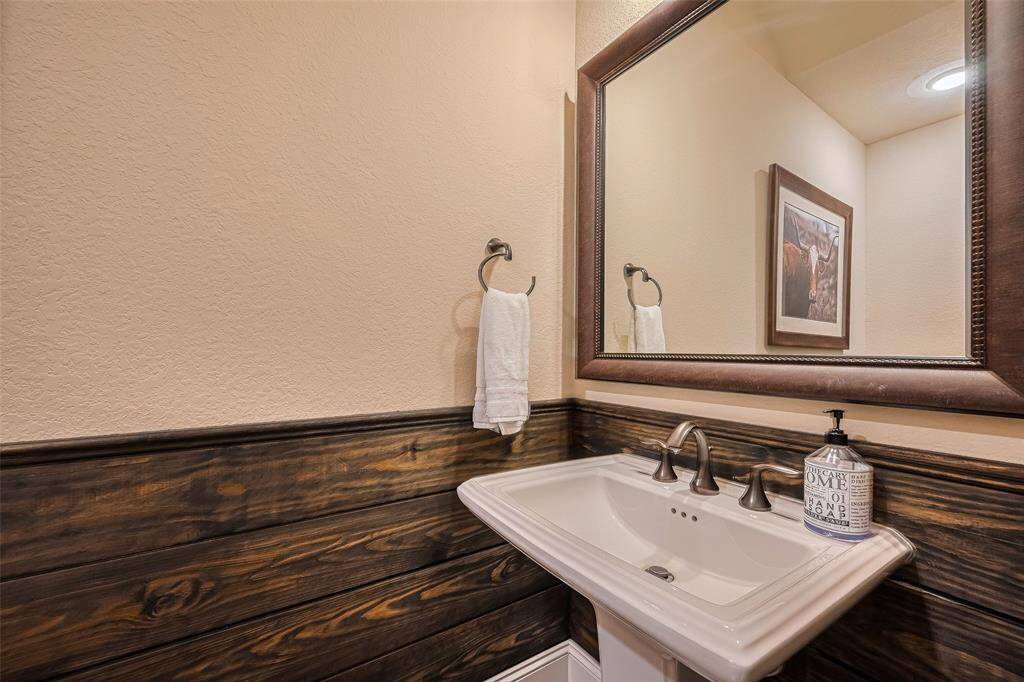 This is the powder bath, located downstairs for Guest with wood slat accent feature wall all around