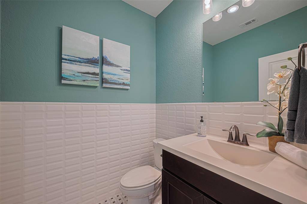 This is the second  - half bath - located upstairs that is unique to this floor plan. Here you see upgraded tile walls surround