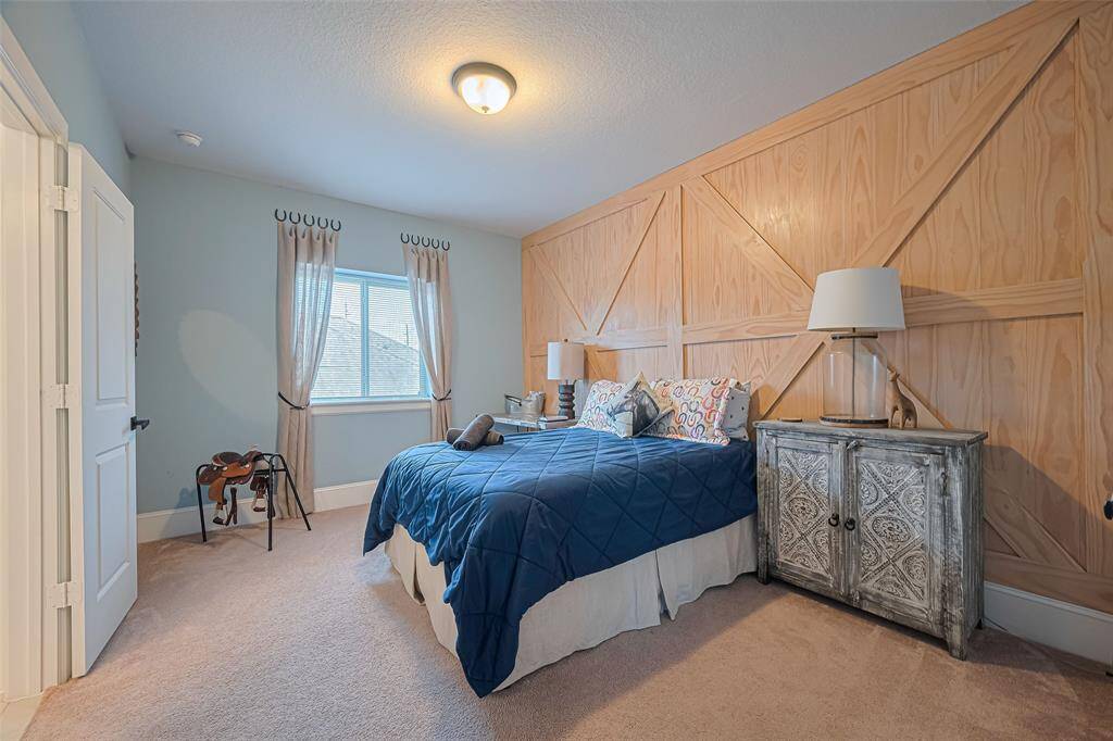 Bedroom number four are also upstairs on the other side of the Jack and Jill bathroom and here you see a beautiful designer accent wall for this room as well