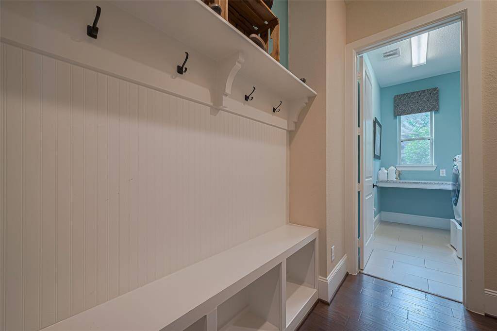 Just off to the garage is the mudroom area with a craftsman style storage nook upgrade
