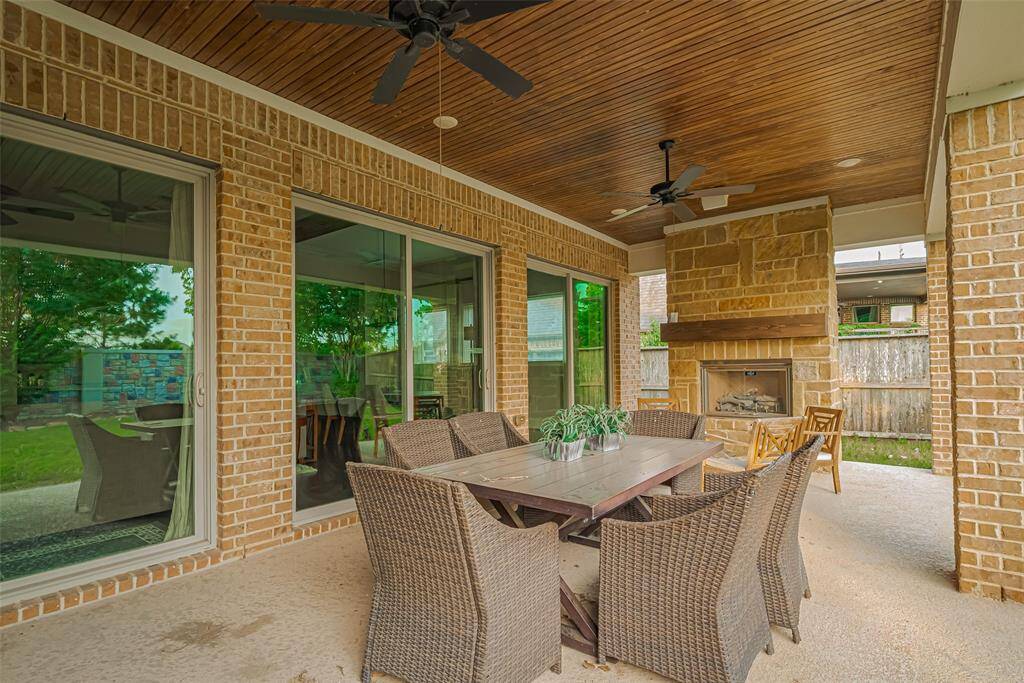Huge covered patio out back with outside fireplace, wood slatted ceiling, and just an amazing place to relax