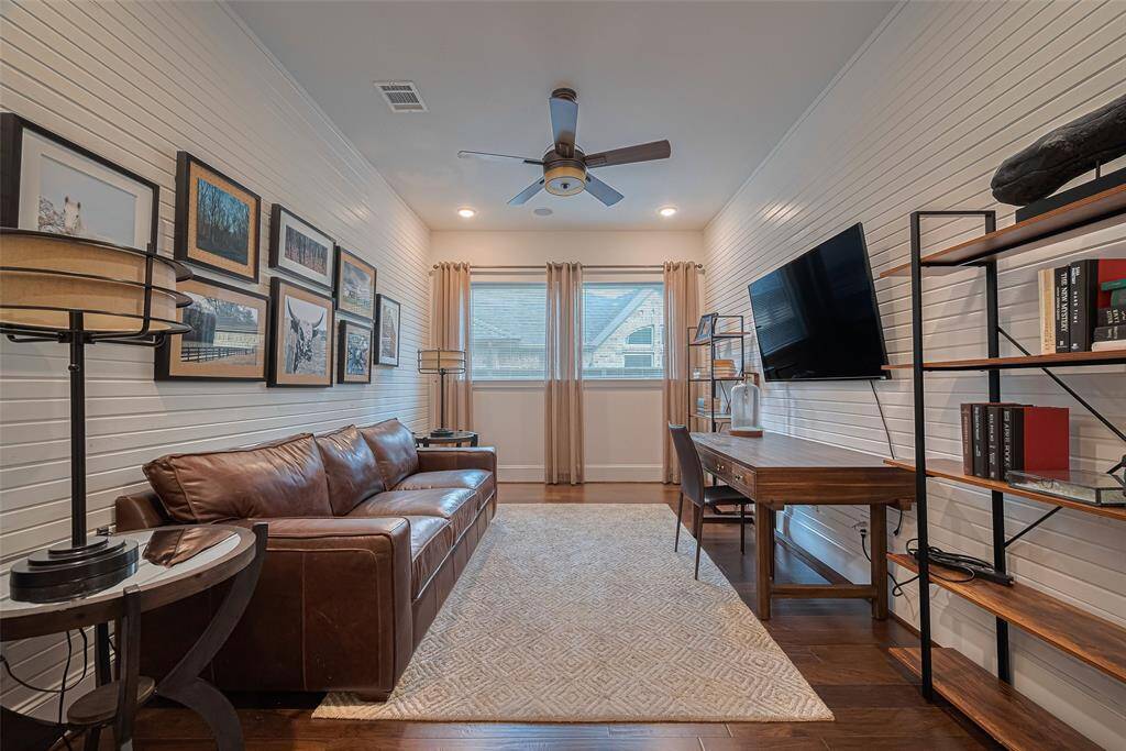 Perfect study with designer feature walls, custom drapery, and recessed lighting