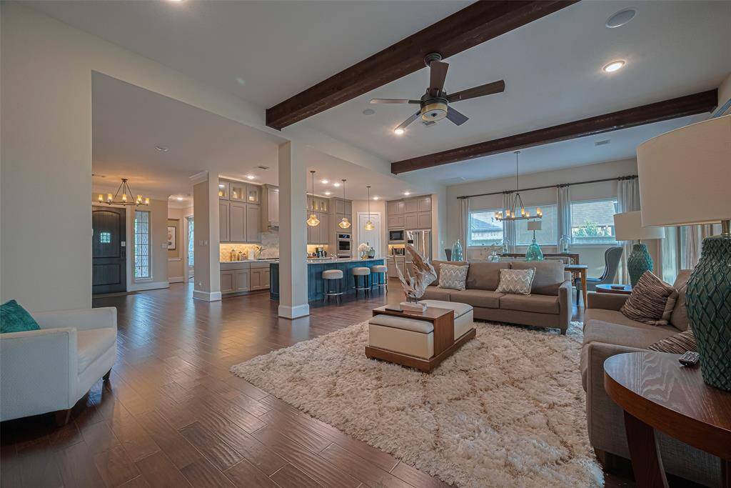 Once again, the open floor plan allows for perfect gatherings and frequent family time. The  designer ceiling beams show off further design elements