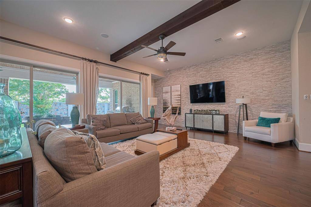 An amazing wall of window doors that also give access to the back patio, but also bring in beautiful natural light filling the space with warmth