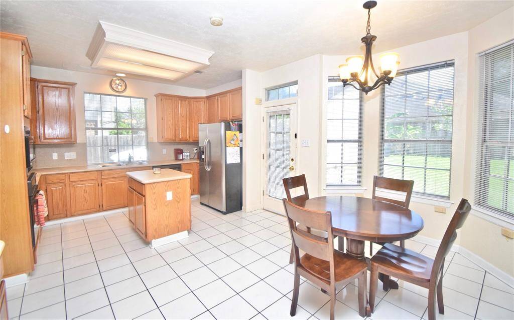 Here is a view of the light and bright kitchen and breakfast area."Home is Occupied"
