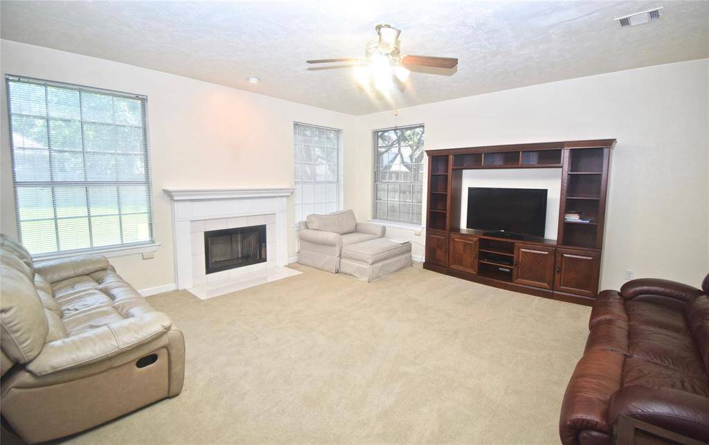 This spacious family room offers a cozy fireplace!