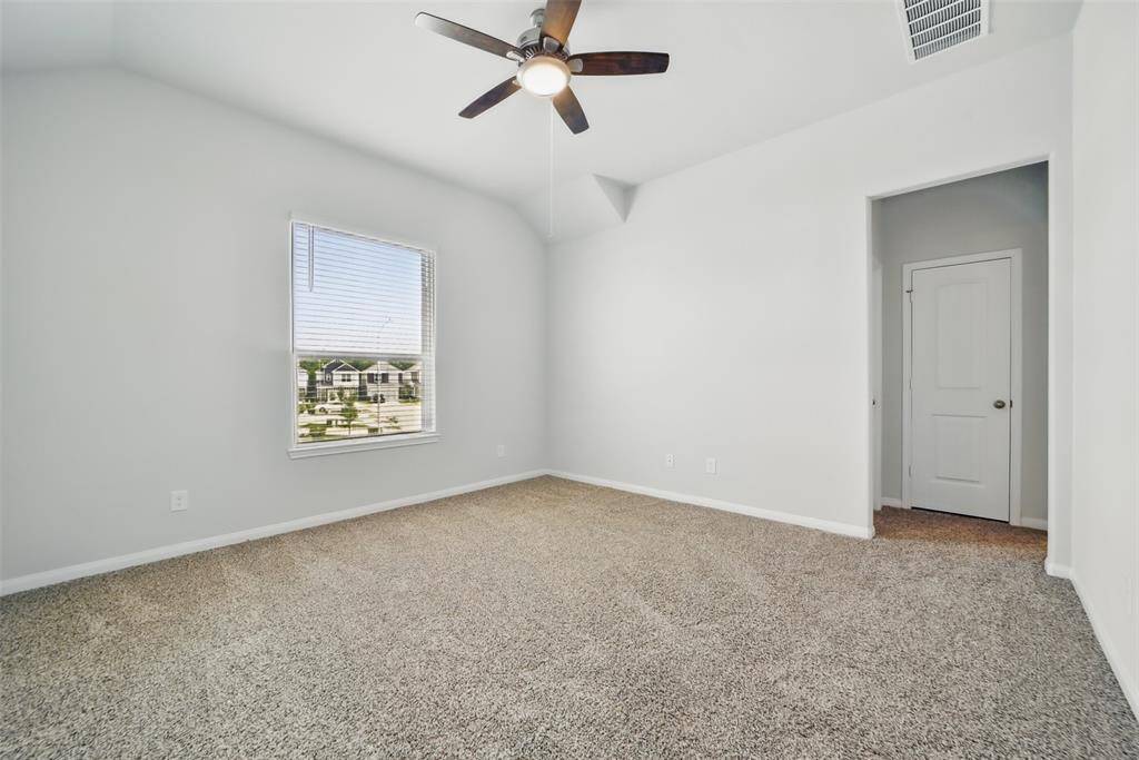 Primary bedroom is spacious with extra high ceiling and fan