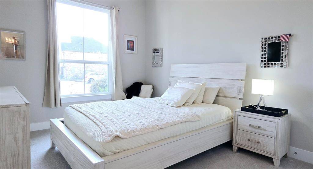 Guest suite features large windows to provide natural light with an en-suite full bathroom