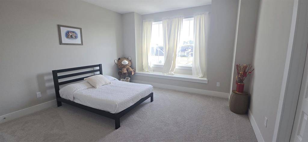 inviting upstairs bedroom with a built-in window bench, perfect spot for reading or enjoying the view with natural light.