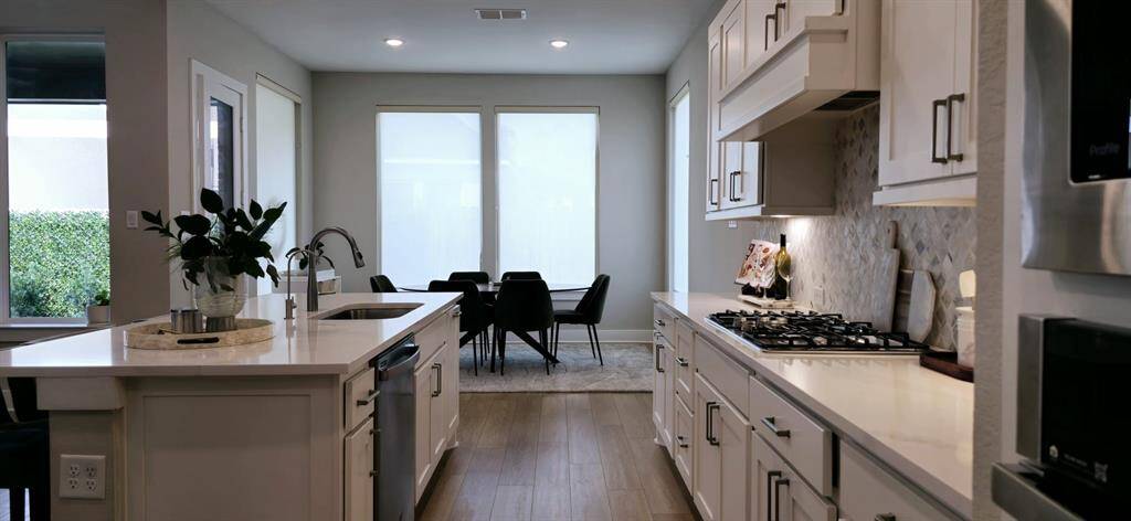 large island with barstool seating serves as a casual dining area, separate breakfast area perfect for enjoying everyday meals.