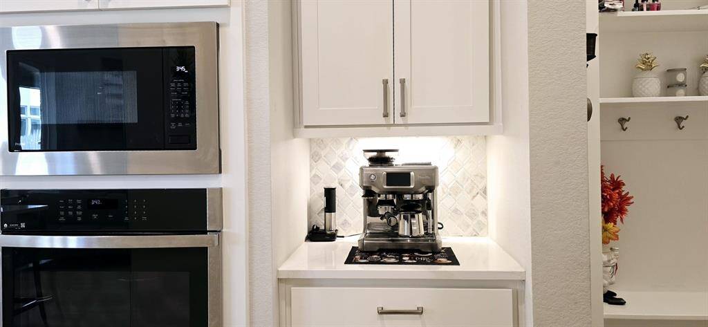 Butler's pantry with cabinetry provide an extra workspace for coffee-making.