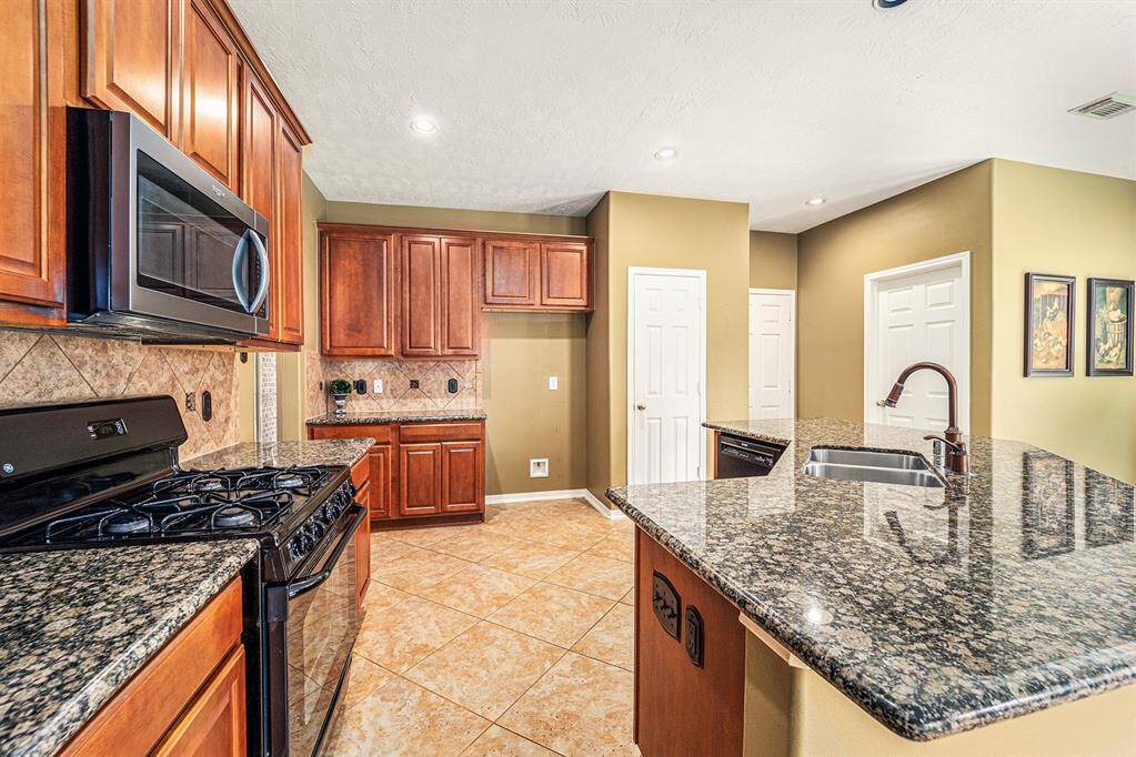 This kitchen features a gas range, built-in microwave and space for a refrigerator!