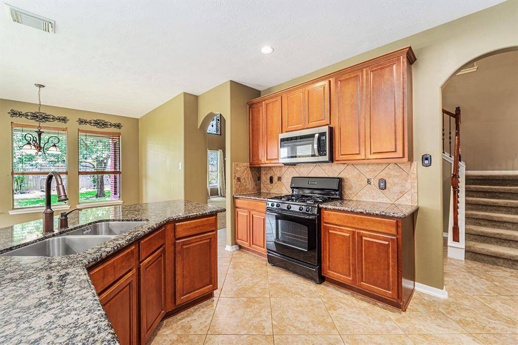 We love the design of this home with the convenience of quick access to the stairs leading to the secondary living spaces...that means midnight pantry raids won't be so bothersome!  And there is also the added feature of extra storage under the stairs!