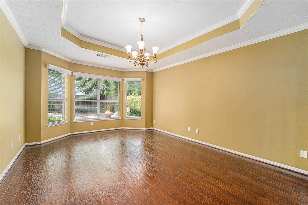 A serene primary suite complete with gorgeous hardwood flooring and a bay window will add in the peaceful slumber in this room!