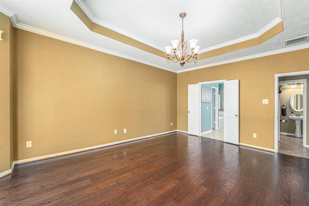 The added details of the crown molding in the tray ceiling and the pretty chandelier just makes this room oh so dreamy!
