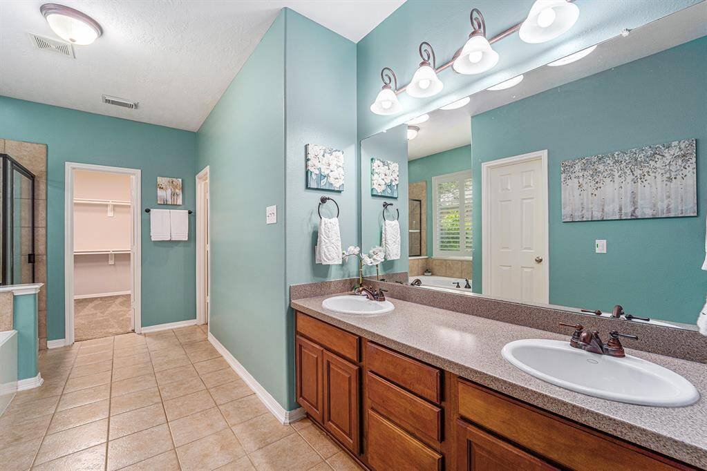 The primary ensuite features a dual sink vanity with cabinets and drawers for storage!