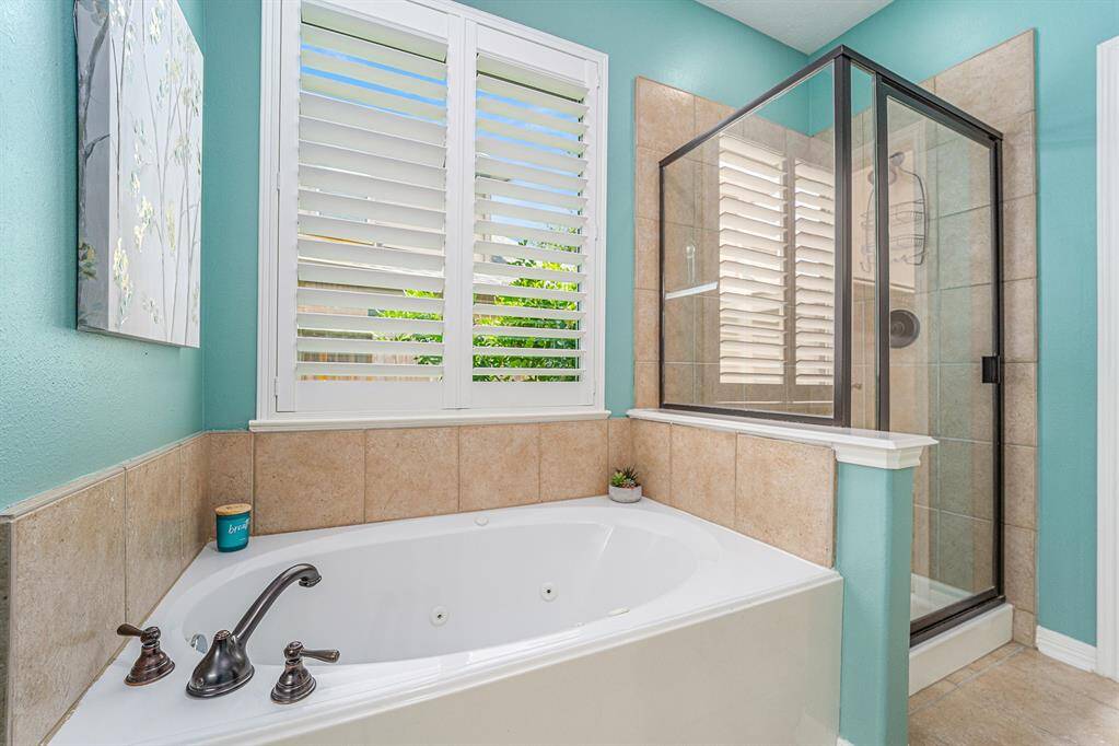 A separate glass enclosed shower and an oval tub with jets, let's you choose if you prefer steam or bubbles to end your day!