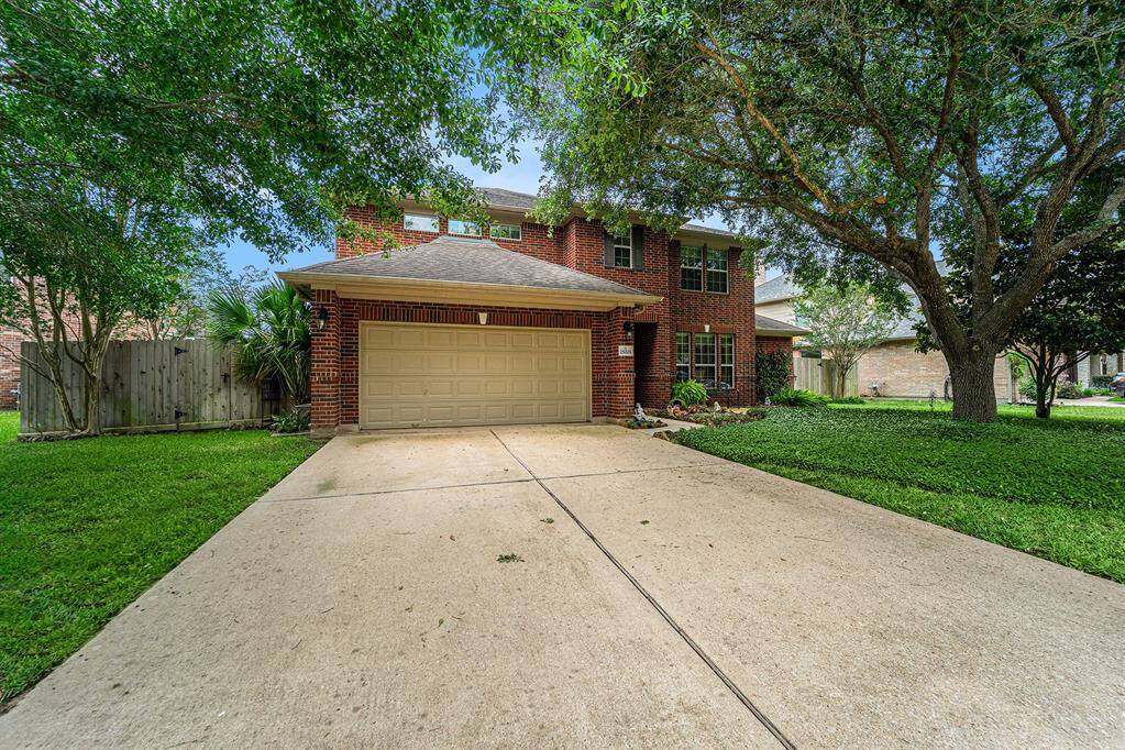 A double-wide drive leads up to this traditional style home with timeless brick exterior!
