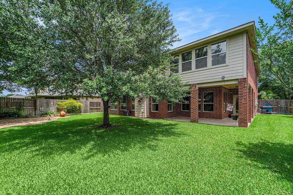 Step outside and enjoy this wonderful backyard greenspace!  A covered patio gives you a spot to beat the heat and a large oak shade tree offers a spot if you want to ground to the great outdoors!