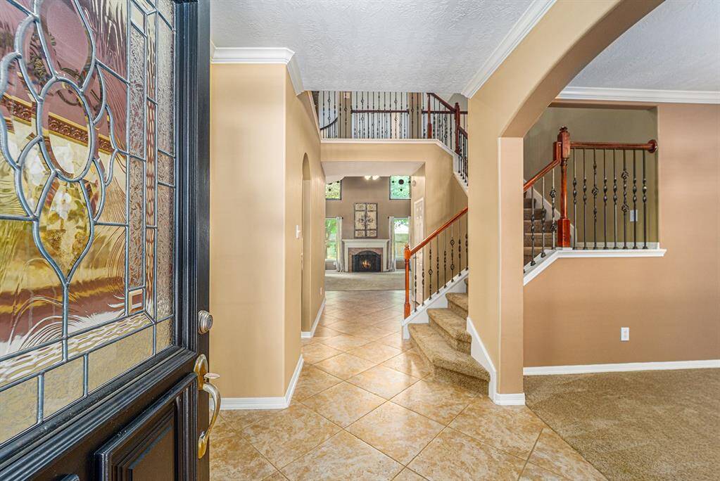 Open the door and enter this warm and inviting home!  The showstopper here is the architectural details from the wrought iron and wooden balusters, the cat-walk and the natural light that flows throughout the space!