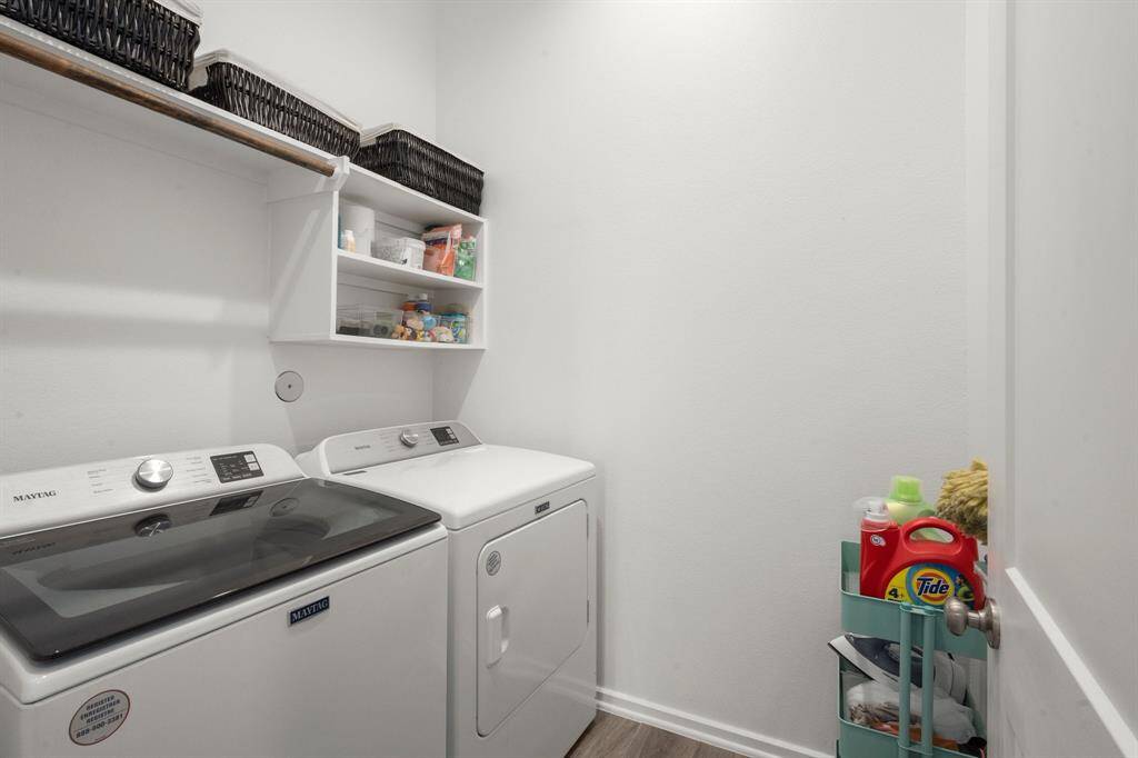 Dedicated laundry room with storage and hanging space.
