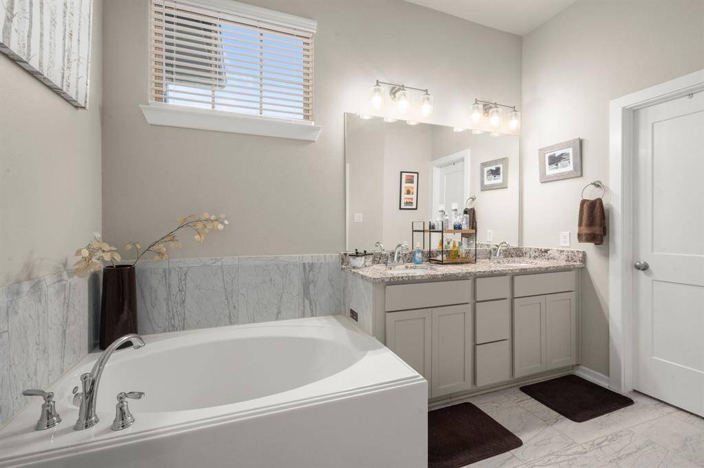 Primary bath with double sinks and soaking tub.